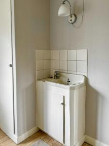 a white bathroom with a sink and a mirror at Big House With A View Over Forest Lake in Hölö +32 photos