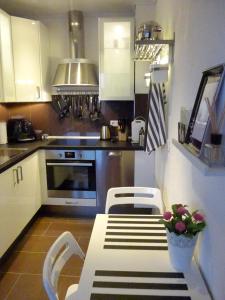 a kitchen with a table and two chairs in it at City Apartments Will in Emmerich