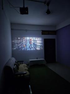 a dark room with a large painting on the wall at Aabir Home Stay in Guwahati