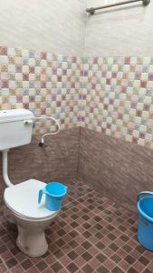 a bathroom with a toilet and a shower at kanyakumari home stay in Jāmb