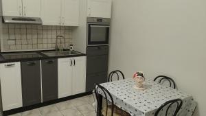 a kitchen with a table with a table cloth on it at Hoya Room & Living in Bari