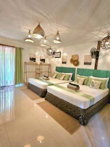 a bedroom with two beds in a room at Siargao Alcove Verde Eco-Sanctuary Hostel in General Luna