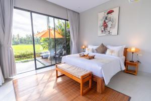 a bedroom with a large bed and a large window at Sierra Vista 2 Ubud in Ubud +68 photos