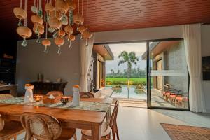 a dining room with a table and a view of a patio at Sierra Vista 2 Ubud in Ubud
