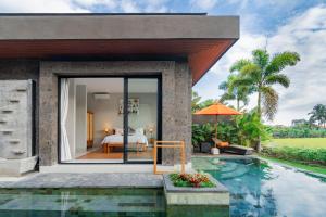 a bedroom in a villa with a pool at Sierra Vista 2 Ubud in Ubud