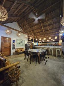 a dining room with a table and chairs at Siargao Alcove Verde Eco-Sanctuary Hostel in General Luna