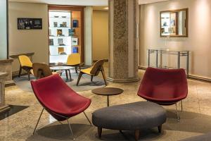 a group of chairs and tables in a lobby at Mercure Joinville Prinz in Joinville
