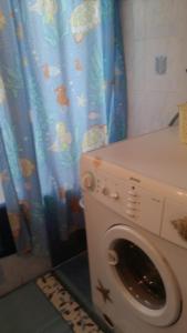 a washing machine in a bathroom with a shower curtain at Duplex Apartment Eleonora in Banjole