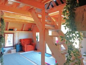 a wooden house with a staircase in a living room at Maria - Brebu Nou in Brebu Nou +37 photos