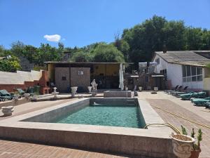 a swimming pool in the middle of a courtyard at Casa Rico in Tulcea +7 photos