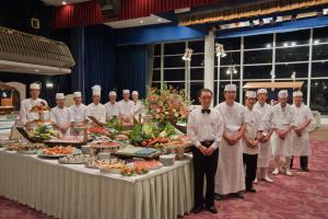 a group of chefs standing in front of a table with food at Hatoya Hotel in Ito