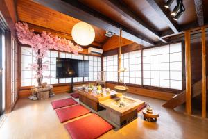 a large living room with a television and a large room with at 東京駅まで30分 日本の囲炉裏 1棟貸切 16名 130平米 2バスルーム パノラマビュー 桜 富士山 in Ichikawa +44 photos