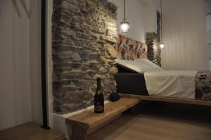 a bedroom with a bed and a bottle of wine at B&B la cruna deLago in Omegna