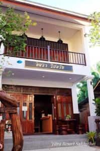 a building with a sign on the front of it at JITRA RESORT in Sukhothai