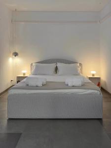 a bedroom with a large bed with two pillows at Arazzo Apartments in Modena