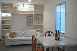 a living room with a white couch and a table at Arazzo Apartments in Modena