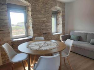 a living room with a table and chairs and a couch at Myrtia Apartments in Mytilinioí