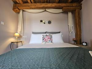 a bedroom with a large bed with a canopy at RAVANIS Home in Áyios Pétros