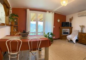 a dining room with a table and chairs and a fireplace at Gîte Bien Etre in Boulogne-sur-Gesse +15 photos