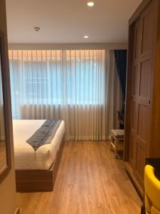 バンコクにあるApartment in Central Sukhumvitのベッドと大きな窓のある寝室 +10枚の写真