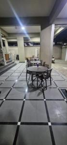 a room with tables and chairs on a tiled floor at Sunrise Service Apartment in Dāpuri