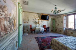 a room with a table and a painting on the wall at AGRITURISMO CASTELLO BECCARIA in Pieve del Cairo