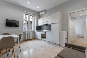 a kitchen and living room with a table and a couch at MI Michetti 20 in Milan +13 photos