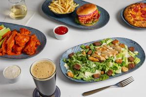 a table with plates of food and a sandwich and fries at Hyatt Place Secaucus Meadowlands in Secaucus
