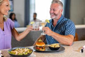 a man and a woman sitting at a table with food at Hyatt Place Secaucus Meadowlands in Secaucus