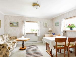 a living room with a table and a couch at 5 person holiday home in BULLAREN-By Traum in Stabäckehult