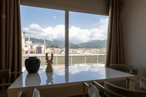 a table with a vase sitting on top of a window at Central Luxury Penthouse in Kalamata