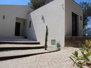 a house with white walls and stairs on the side at State of the Art Fixtures Villa in Vidauban with Pool in Vidauban