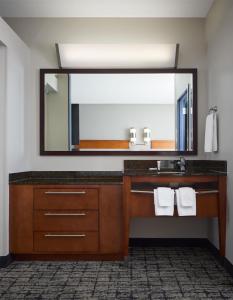 a bathroom with a sink and a mirror at Hyatt Place Salt Lake City Downtown / The Gateway in Salt Lake City