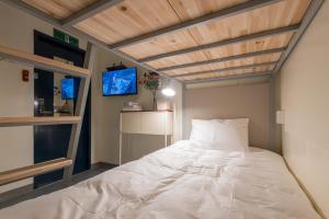 a bedroom with a bed with a wooden ceiling at Nomad Hostel in Seoul