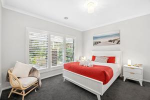 a bedroom with a bed and a chair and a window at Saltwater in Anglesea