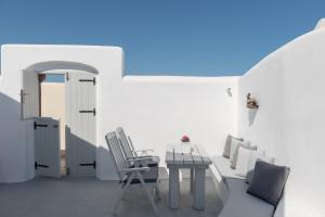 a white room with a table and chairs at Sensation Villa - by Senses Collection in Pirgos