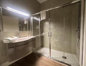 a bathroom with a shower and a sink at Alèa Rooms in Lecce