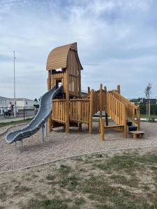 a playground with a slide and a gazebo at luxe cottage knokke heist in Knokke-Heist