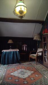 a living room with a table and a rug at LE VIEIL HERMITAGE in Ervauville