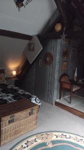 a bedroom with a bed and a rug on the floor at LE VIEIL HERMITAGE in Ervauville