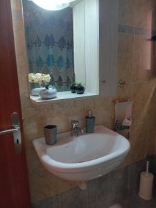 a bathroom with a sink and a mirror at Poly's house in Loutsa +22 photos
