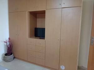 a cabinet with a tv on top of it at Poly's house in Loutsa +22 photos