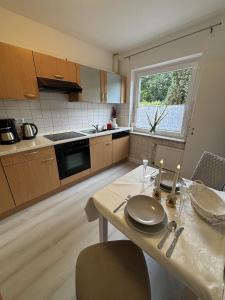 a kitchen with a table with plates and candles on it at Ferienhaus Lamia in Bispingen +14 photos