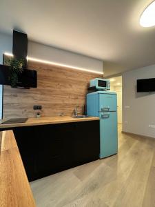 ルーゴにあるApartamentos muralla de Lugoのキッチン(青い冷蔵庫、電子レンジ付)