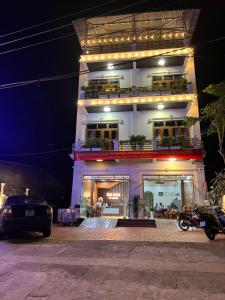 a building with lights on top of it at night at Đá Gió Hà Giang Homestay in Ha Giang