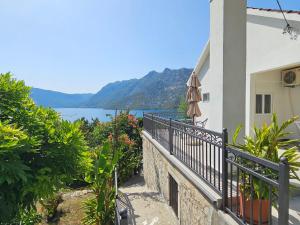 a balcony of a house with a view of the water at Apartment Rose Garden in Risan