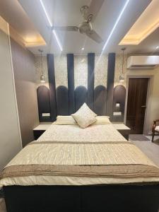 a bedroom with a large bed with a blue headboard at The Cerro Rico- 3BHK Premium Apartment in Panchkula