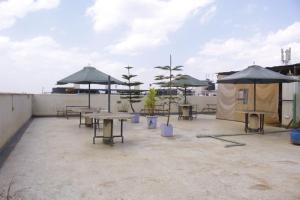 a patio with tables and umbrellas on a roof at 10 minutes to Karura forest Studios in thindigua Kiambu in Nairobi