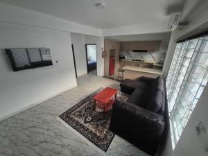 a living room with a couch and a table at Rogo Soqo Homestay in Nadi