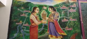a painting of two women holding a idol at Pavana Guest House in Pedda Ahobilam +2 photos